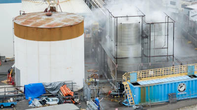 Water is sprayed on a damaged tank at GKN Aerospace in Garden Grove, Calif., on Sunday, May 24, 2026, after the tank containing a chemical used to make plastic parts overheated Thursday.