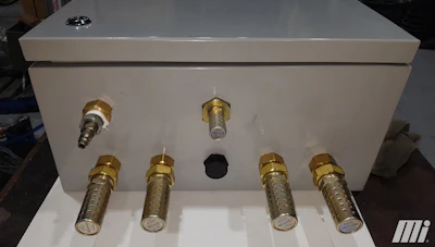 Figure 3. The metallic silencers exhaust the ducted air outside the panel.