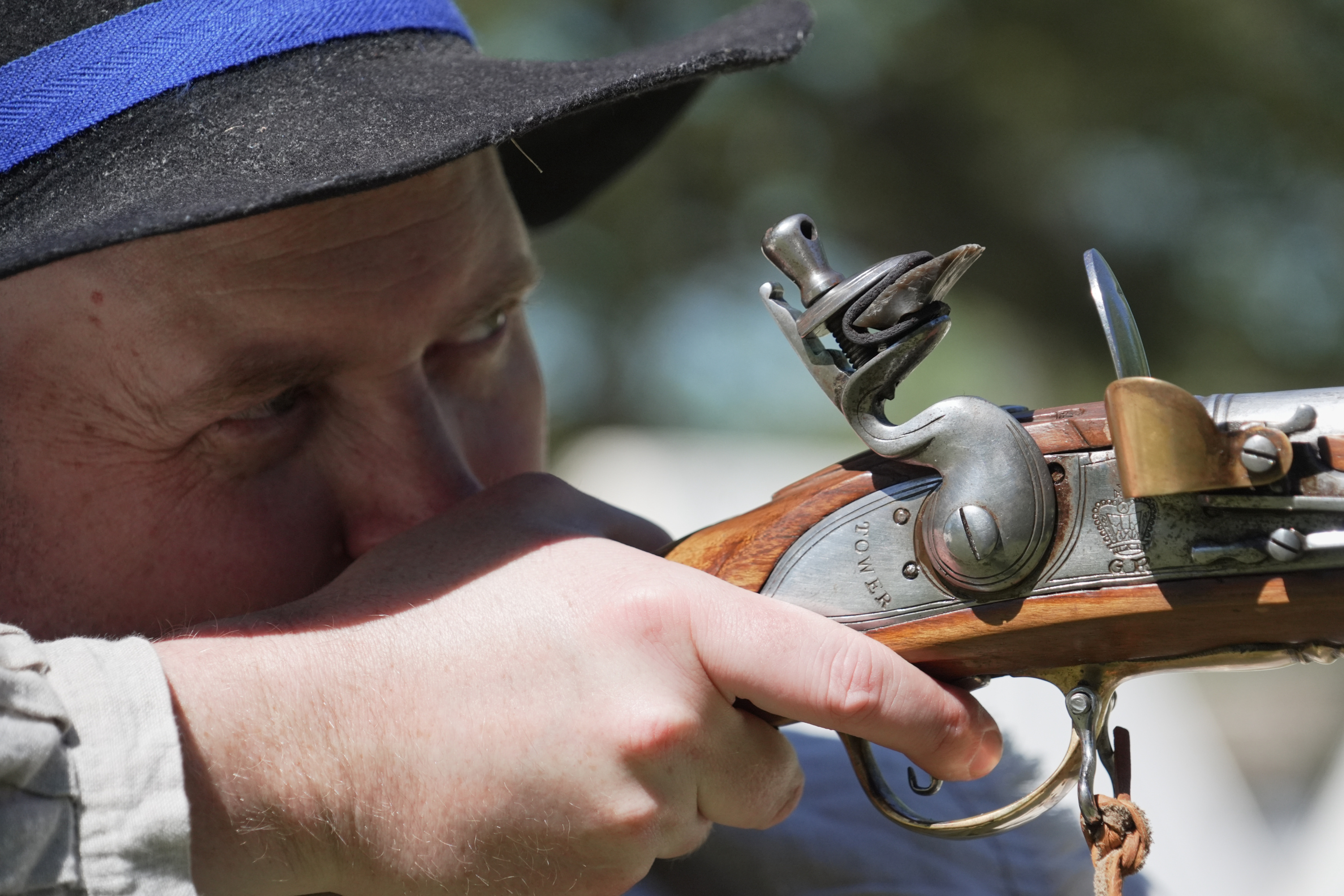 A.J. Drake, a historic interpreter, aims his Brown Bess flintlock replica musket during a Revolutionary War event in Halifax, N.C., on April 10, 2026.