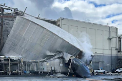 This photo provided by the City of Longview, Wash., shows structural damage to the Nippon Dynawave Packaging Co., after a tank containing hazardous liquid imploded, on Tuesday, May 26, 2026 in Longview, Wash.