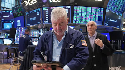 Trader Edward McCarthy, center, works on the floor of the New York Stock Exchange, Tuesday, May 5, 2026.