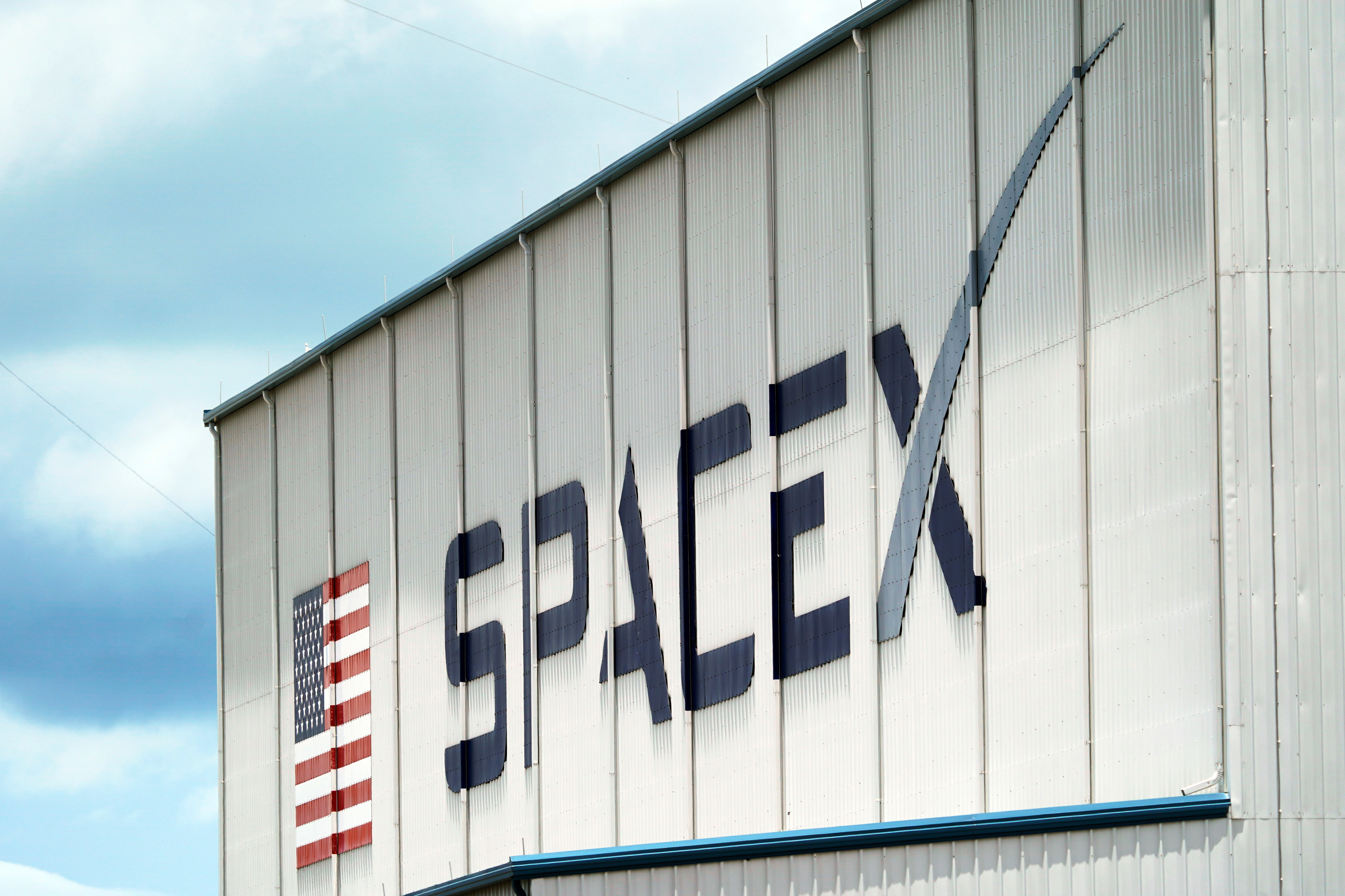 A SpaceX logo is displayed on a building, May 26, 2020, at the Kennedy Space Center in Cape Canaveral, Fla.