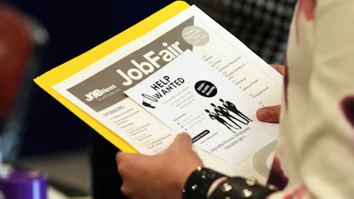 A job seeker waits to talk to a recruiter at a job fair, Aug. 28, 2025, Sunrise, Fla.