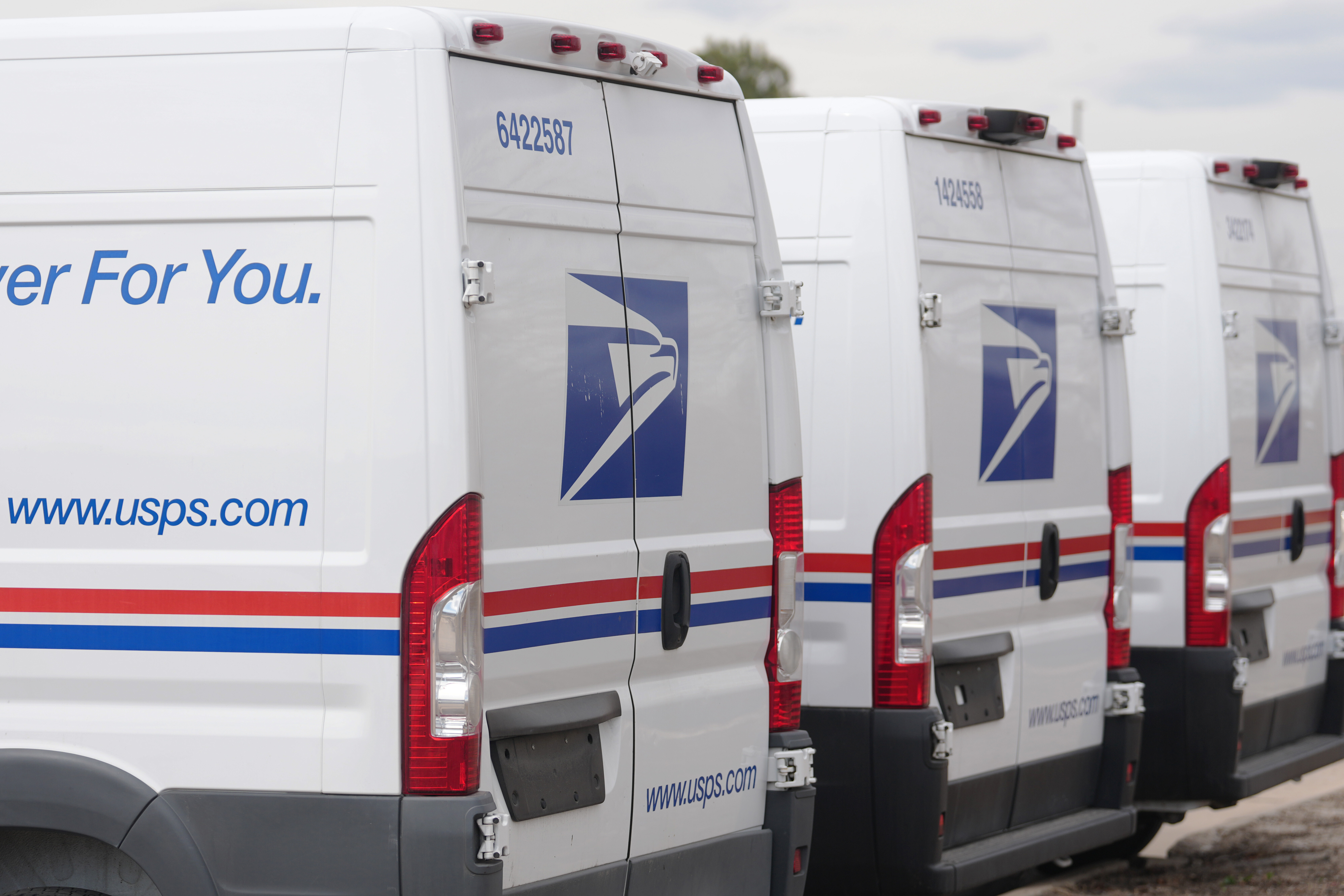 USPS delivery vans in Denver, March 23, 2026.