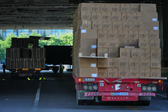 Workers transfer goods from a truck at the Xiaomi logistic center, Beijing, May 29, 2026.