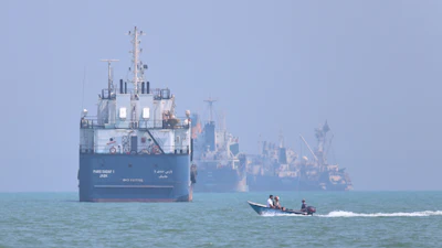 A motorboat passes anchored vessels in the Strait of Hormuz off Bandar Abbas, Iran, June 11, 2026.
