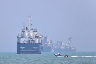 A motorboat passes anchored vessels in the Strait of Hormuz off Bandar Abbas, Iran, June 11, 2026.