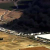 This image from aerial video shows black smoke pouring into the sky from a fire at a medical equipment warehouse in Tracy, Calif., Thursday, June 11, 2026.