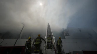 Firefighters fight a warehouse fire in the Boyle Heights neighborhood of Los Angeles, Sunday, June 21, 2026.
