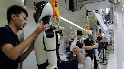 Workers assemble robot at the LY iTech Beijing Super Factory for Embodied Artificial Intelligence during a media tour in the Beijing E-Town on the outskirts of Beijing on May 29, 2026.