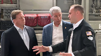 Energy Secretary Chris Wright, center, and Under Secretary of Defense Michael Duffey, left, listen as Isaiah Taylor, CEO of Valar Atomics, discusses a microreactor developed by Valar to generate nuclear power for the military and commercial customers, Feb. 15, 2026, in-flight, on board a C-17.