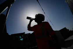 A worker drinks water on a construction site during high temperatures in Boulogne Billancourt, outside Paris, Wednesday, June 24, 2026.