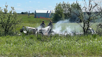 The wreckage of a plane crash burns in a field in Butler, Mo, Sunday, June 14, 2026.