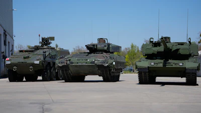 A boxer armoured personnel carrier, from left, a Puma infantry fighting vehicle and a Leopard battle tank are displayed during the opening of a new production line production line of Boxer 8x8 wheeled armoured personnel carrier produced by pan-European defense company KNDS in Munich, Germany, on April 22, 2026.