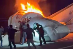 A passenger, top, jumps out of a plane after it crashed on a highway as other people help Tuesday, June 16, 2026, in Laredo, Texas.