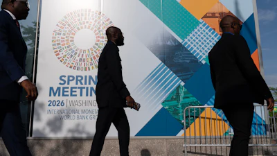Delegates walk to the entrance of the International Monetary Fund headquarters during the World Bank/IMF Spring Meetings in Washington, April 15, 2026.