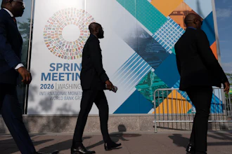 Delegates walk to the entrance of the International Monetary Fund headquarters during the World Bank/IMF Spring Meetings in Washington, April 15, 2026.