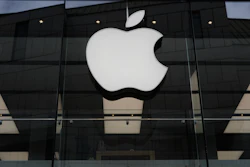 The Apple logo is illuminated at a store in Munich, April 2, 2026.