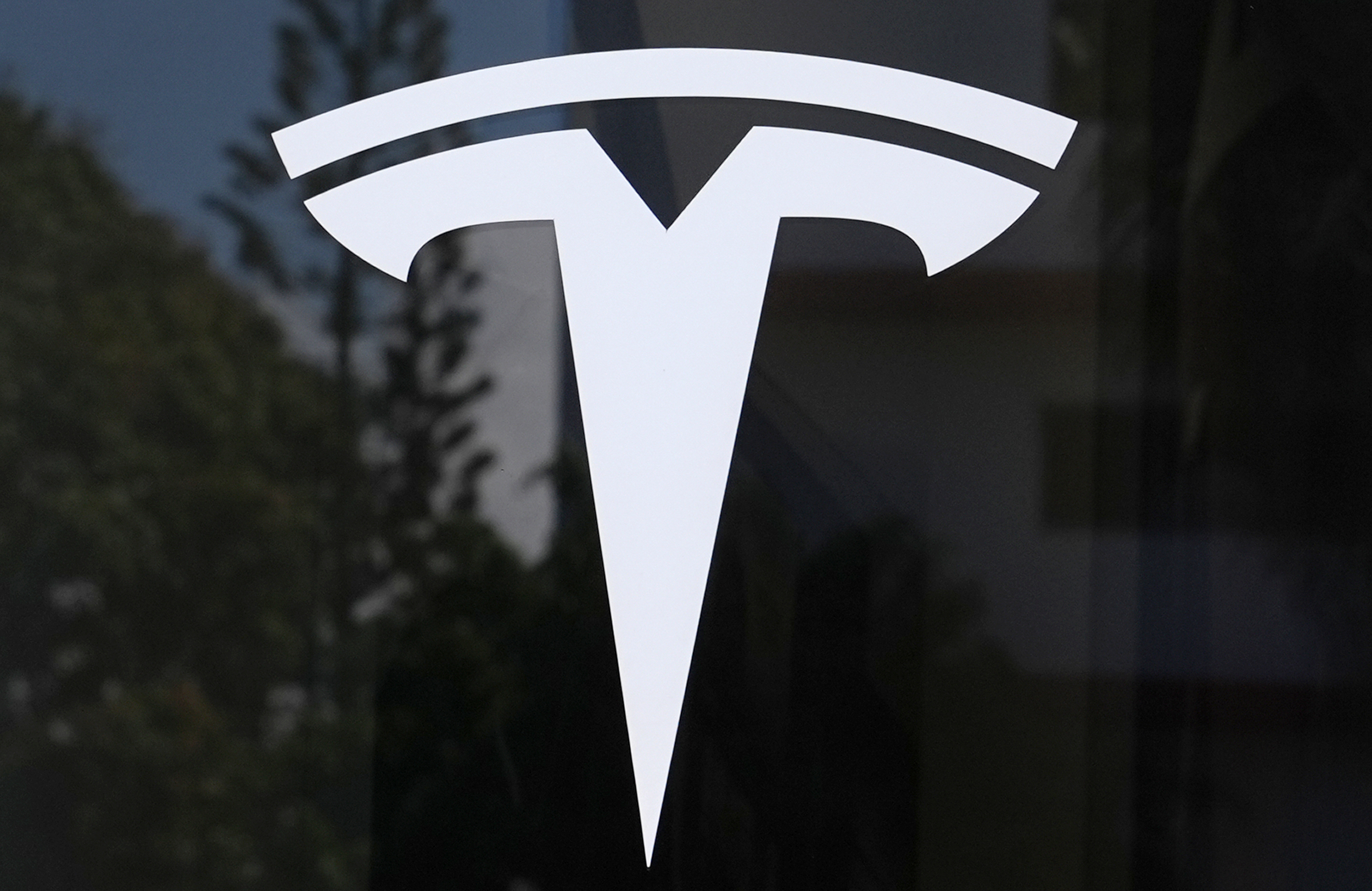 The Tesla logo is displayed at a Tesla dealership, Mar. 13, 2025, in Miami.