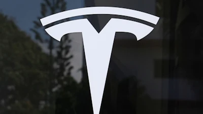 The Tesla logo is displayed at a Tesla dealership, Mar. 13, 2025, in Miami.