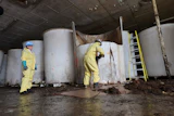 Sludge pours out of a vat of fermenting fish sauce in an abandoned factory, St. Mary's, Newfoundland and Labrador, July 28, 2026.
