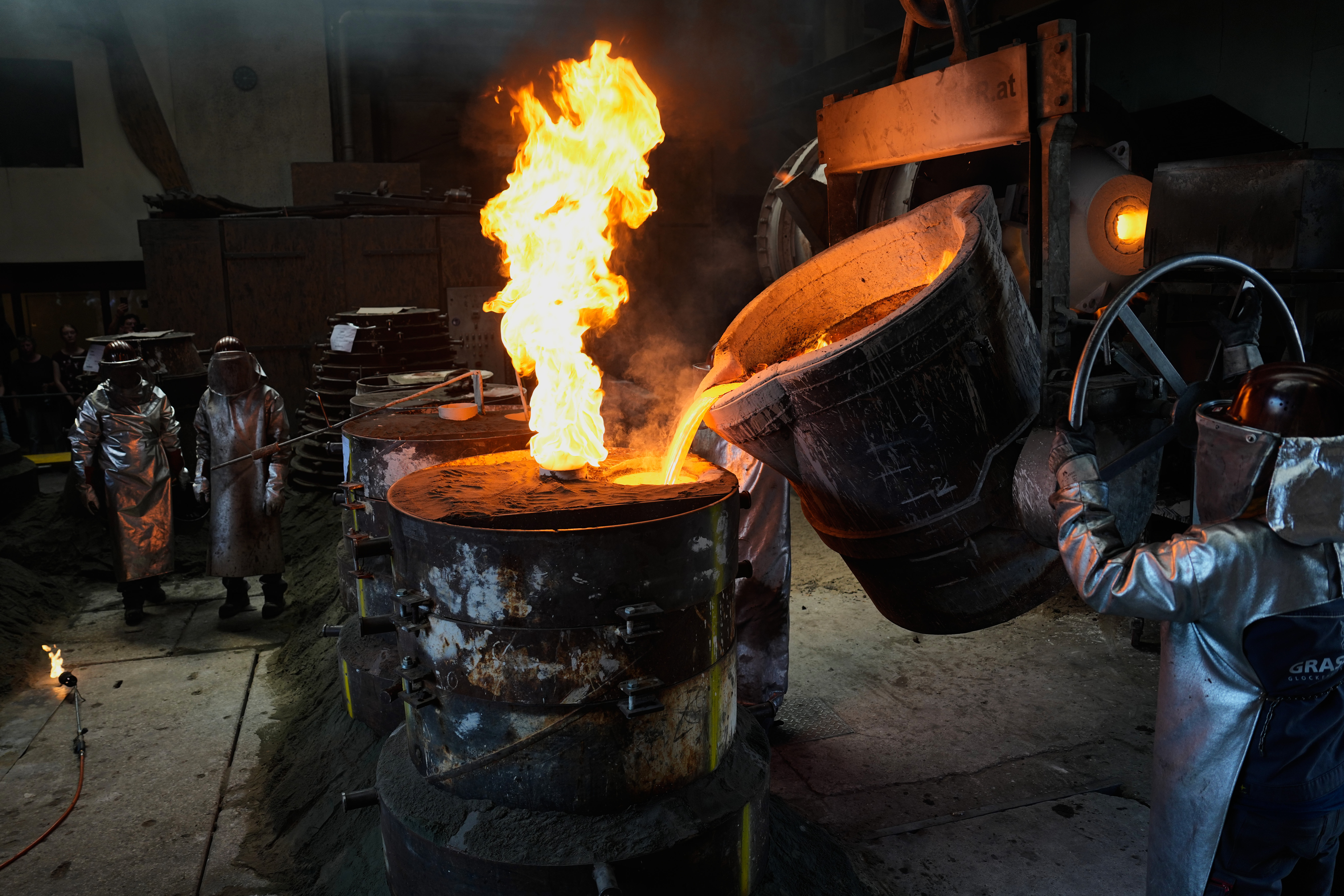 Workers cast bronze bells at the 400-year-old, family-owned Grassmayr bell foundry in Innsbruck, Austria, Friday, July 17, 2026.