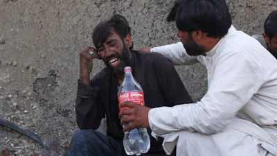 A man comforts a miner mourning fellow miners killed in an explosion at a coal mine on the outskirts of Quetta, in southwest Pakistan, Thursday, July 30, 2026.