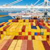 Cargo containers line a ship at the Port of Oakland on Wednesday, Aug. 6, 2025, in Oakland, Calif.