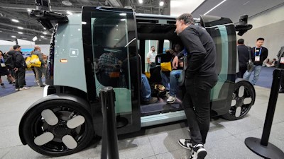 People view a Zoox self-driving vehicle at the company's booth during the CES tech show, Jan. 7, 2025, in Las Vegas.