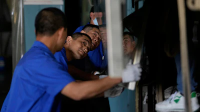 A worker prepares aluminum panels for coating at a factory of Kam Pin Industrial (HK) Ltd., Dongguan, China, April 17, 2025.