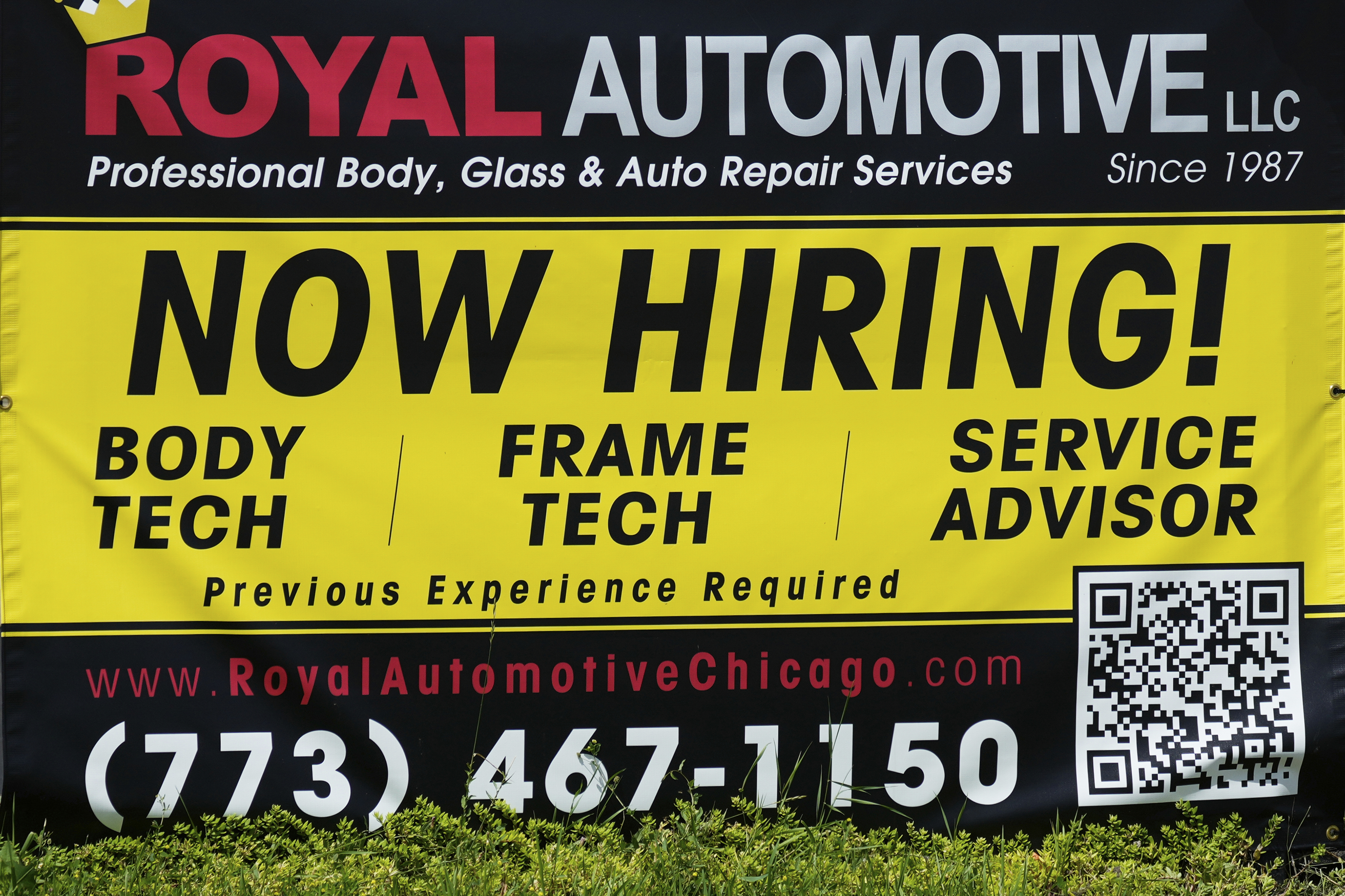 A now hiring sign is seen in front of an auto body shop in Chicago, June 25, 2026.