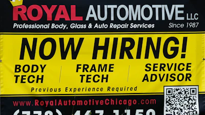 A now hiring sign is seen in front of an auto body shop in Chicago, June 25, 2026.