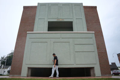 Wesley Mast, owner and president of Coppes Napanee, walks past a giant replica of a Hoosier cabinet in Nappanee, Ind., Thursday, Aug. 6, 2026.