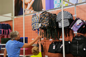 Shoppers look at backpacks at a Target store, Aug. 13, 2026, Woodbury, Minn.