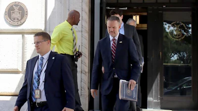 United States Trade Representative Jamieson Greer, center, leaves the U.S. Department of Commerce following a meeting with Canadian officials, Aug. 17, 2026.