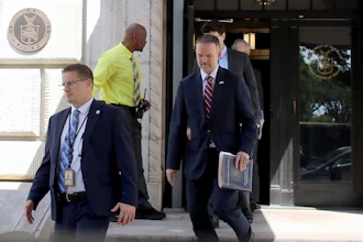 United States Trade Representative Jamieson Greer, center, leaves the U.S. Department of Commerce following a meeting with Canadian officials, Aug. 17, 2026.