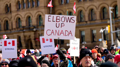 Signs at a rally on Parliament Hill in Ottawa, March 9, 2025.