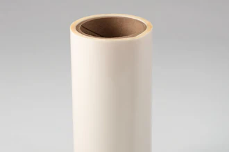 Empty cream-colored cylindrical cardboard tube with brown interior on neutral background