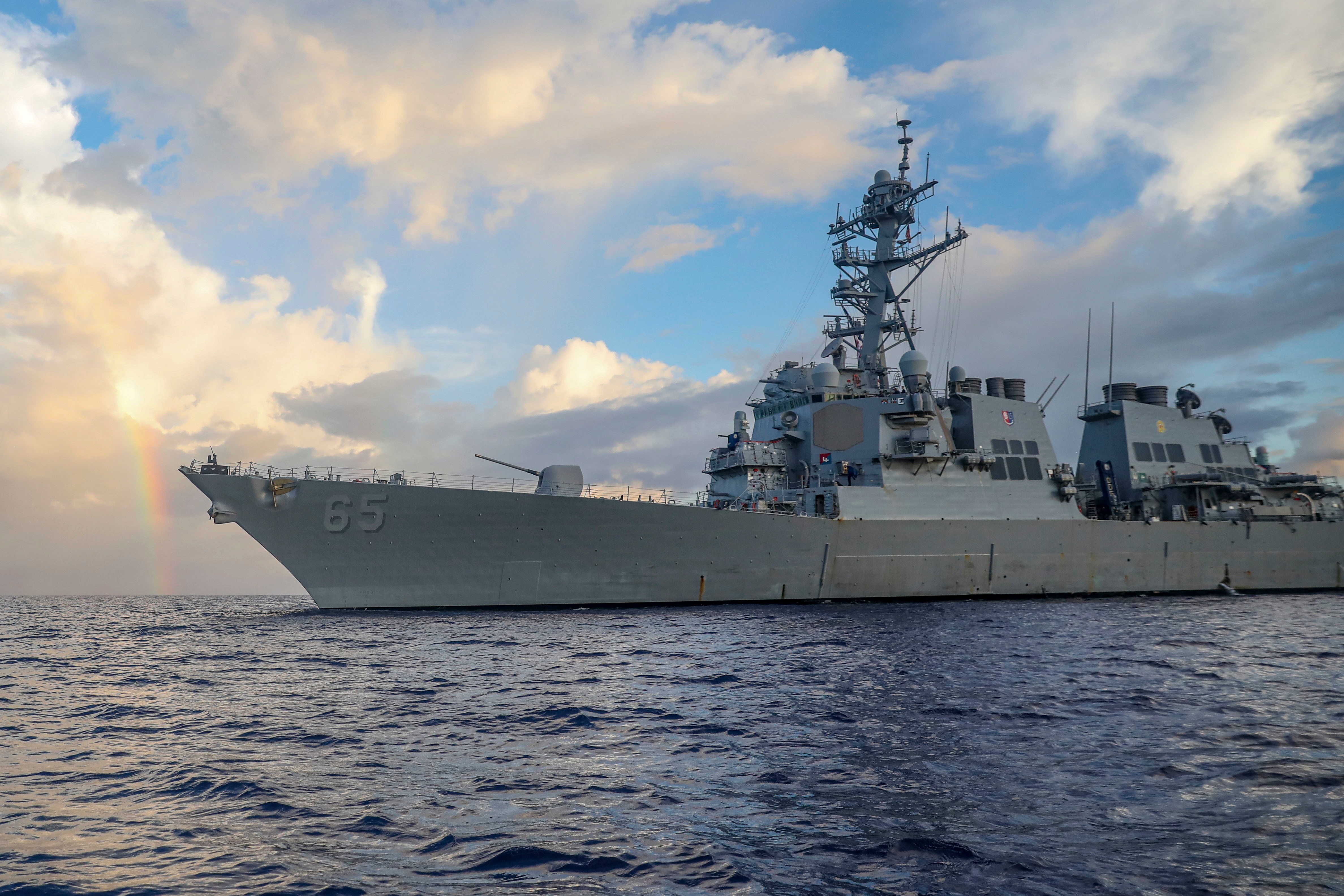 In this photo provided by U.S. Navy, Arleigh Burke-class guided-missile destroyer USS Benfold (DDG 65) conducts routine underway operations in the Philippines Sea on June 24, 2022.