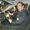 Hiroshi Okuda, then, president of Toyota Motor Corp., smiles as he sits at the steering wheel of the 'Aristo,' Toyota's remodeled sports sedan during a press conference at a Tokyo hotel, Aug. 27, 1997.