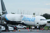 Workers inspect an Amazon cargo plane that overshot a runway four days ago at Miami International Airport, Thursday, Sept. 10, 2026, in Miami.