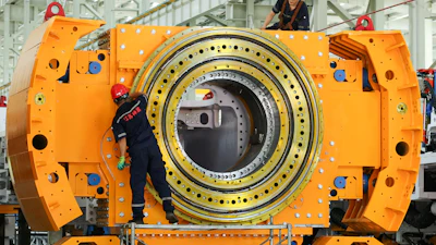Workers install a tunnel‑boring machine at a factory in Jinhu county in eastern China's Jiangsu province on Aug. 25, 2026.