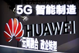 Signs promoting 5G wireless technology from Chinese technology firm Huawei are displayed at the PT Expo in Beijing on Sept. 26, 2018.