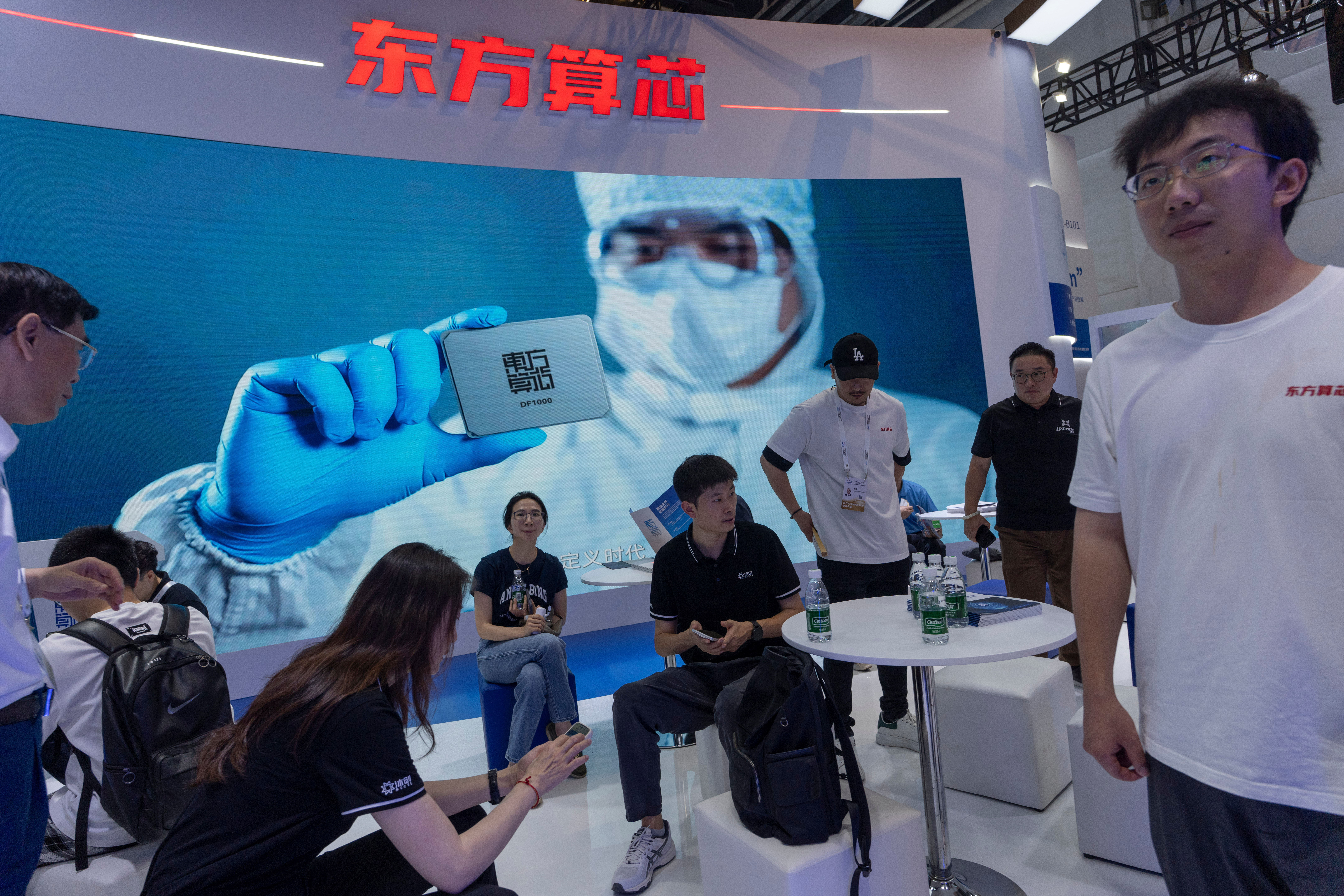 People visit the booth for Chinese AI-computing chip start up Dongfang Suanxin during the World AI Conference in Shanghai, July 17, 2026.