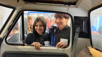 Students from Flandreau Indian School in South Dakota inspect a 1976 Ford F-350 utility truck.