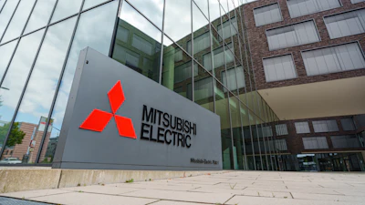 Mitsubishi Electric logo on gray exterior building sign at corporate headquarters entrance