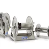 Three stainless steel industrial hose reels of different sizes with manual crank handles