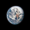 Earth viewed from space showing blue oceans, white clouds, and continental landmasses against black background