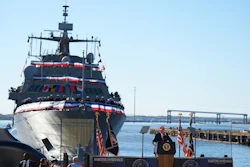 USCGC Maritime Dominance naval vessel at commissioning ceremony with officials and American flags at waterfront dock