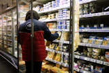 A worker restocking products in a supermarket in Montreuil, France, Oct. 14, 2026.